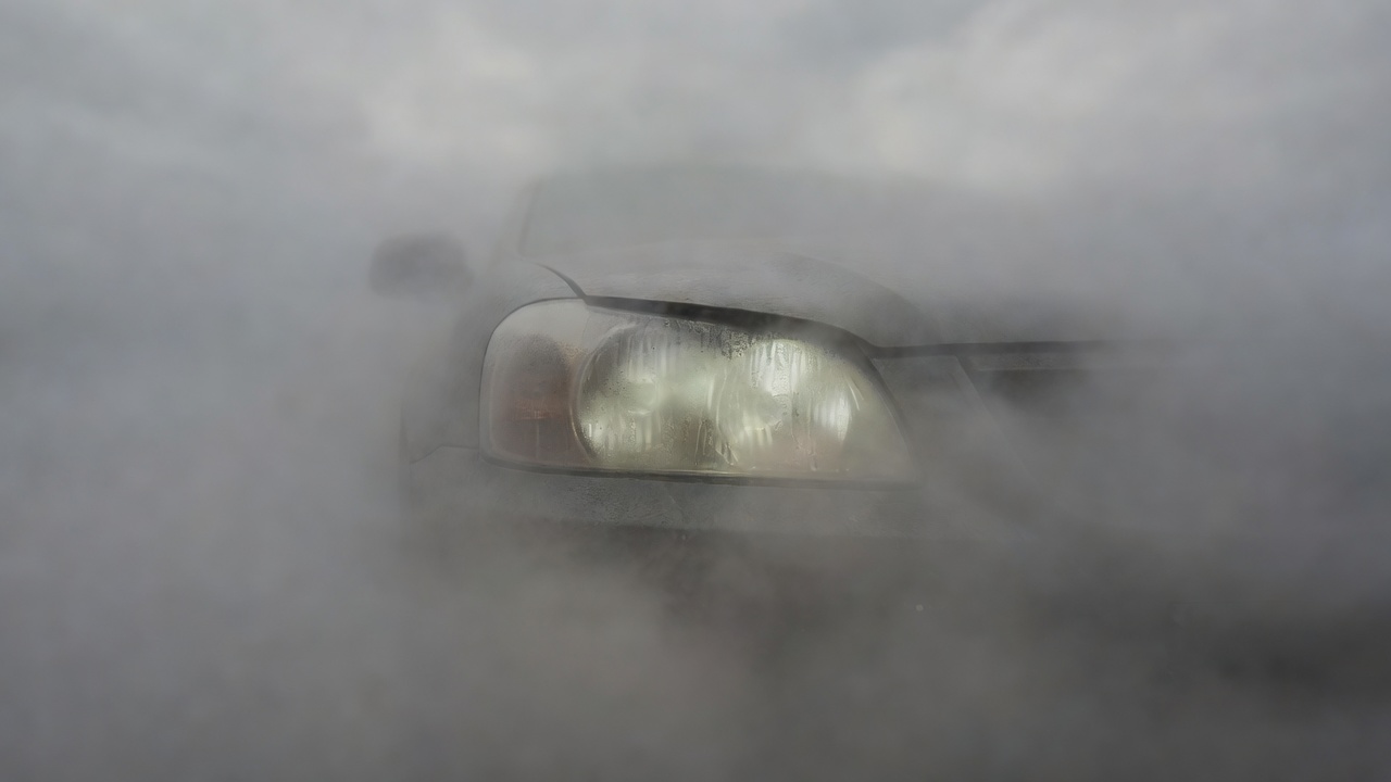 Severely cloudy and hazy vehicle headlight close up